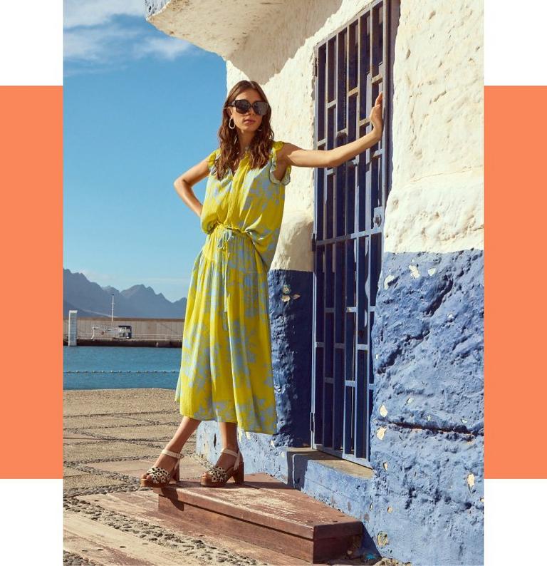 Woman in yellow printed linen summer dress